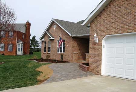 Front of brick home viewing new walkway from drive